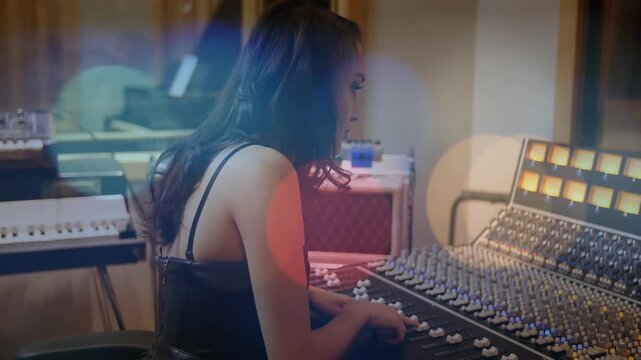 Playback cue starting, audio engineer leaning and adjusting faders and knobs for clean mix balance