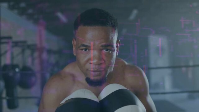 Vertical video: Throwing jab at camera, shirtless boxer practicing jabs in gym ring with gloves