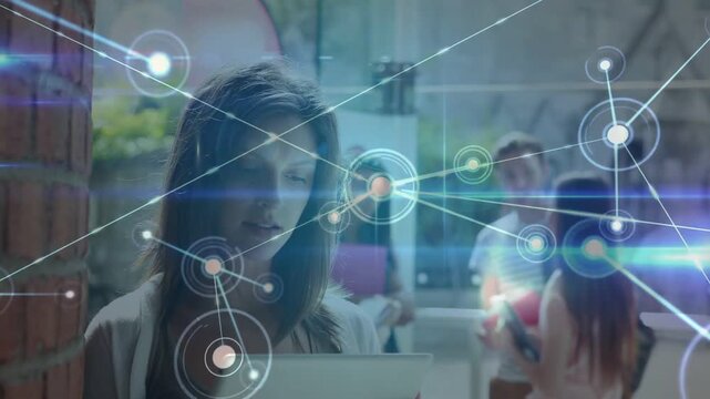 HUD appearing, woman in cardigan tapping tablet on sunlit campus walkway, building network overlay