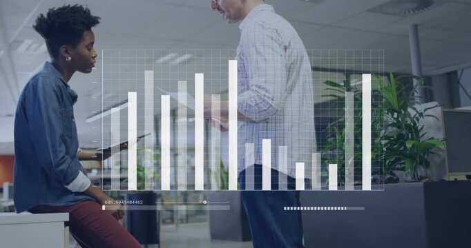 Vertical video: Reviewing data, chart updating, pair tapping tablet and pointing papers in office