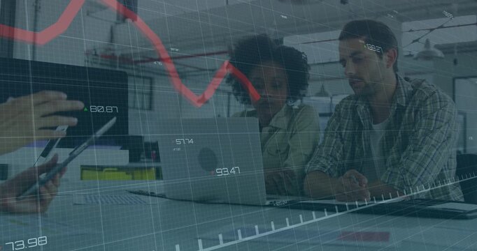 Tapping person scrolling tablet at long table woman in blouse leaning at laptop analyzing red graph