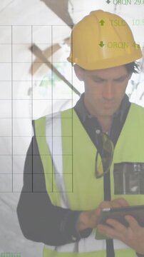 Construction inspector walking tunnel, tapping tablet and showing overlaying charts for inspection