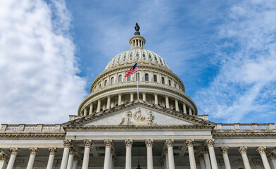 Obraz premium Capitol iconic building in Washington DC skyline. Patriotic exterior architecture in Washington DC cloudy sky. Washington legislation Congress Senate democracy Washington. Historic national landmark.