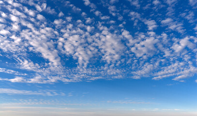 Obraz premium Sky texture with cirrus clouds. Bright sky blue backdrop. Soft white sky wallpaper. Sky cloudscape.