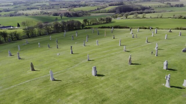 Wide panoramic shot above Vall&eacute;e des Saints Brittany revealing granite saint statues across rolling landscape, highlighting scale and spiritual atmosphere of this iconic tourism hotspot