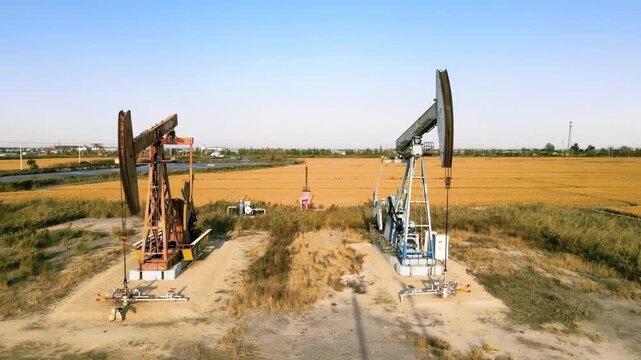 Industrial petroleum fossil fuel extraction equipment, crude oil drilling rigs, pumpjacks machinery pumping derrick in oilfield ground conveying industry power energy global energy consumption
