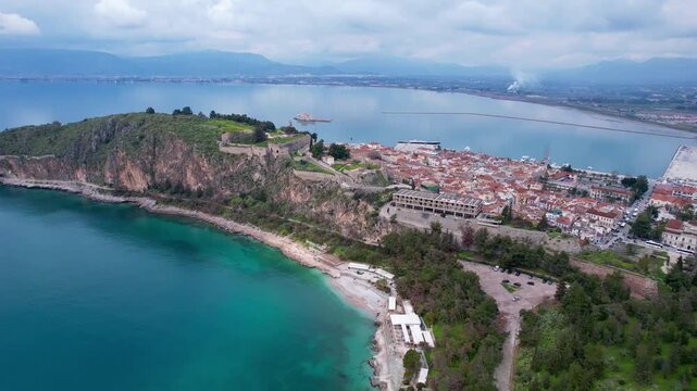 Aerial footage descending toward the historic old town of nafplio and arvanitia beach in greece