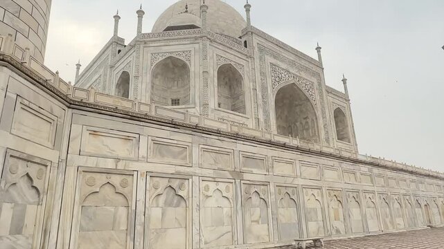 White marble mausoleum with symmetrical Mughal architecture