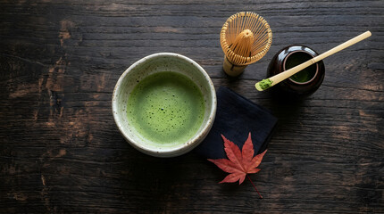 Matcha Tea Set with Bamboo Chashaku and Red Maple Leaf on Dark Wooden Background.