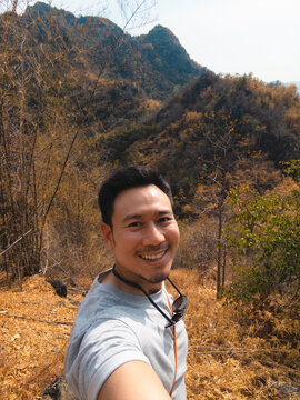 Passionate travel asian man blogger sharing scenic mountain landscape experience