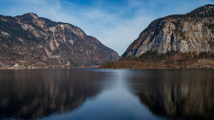 Naklejka premium Alpine lake, river with mountain reflections and dramatic mountains in Austria