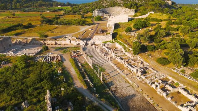 Gelemis, Turkey. Colonnaded Street and Agora at Patara ancient city, center of social and commercial activity in Lycian period. Aerial View, Departure of the camera, MasterShots