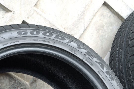  New GOODYEAR car tires on the background of a concrete wall. A set of GOODYEAR Eagle Sport 2 summer, high-quality, reliable car tires. GOODYEAR is a tire manufacturer based in Akron, Ohio, USA.