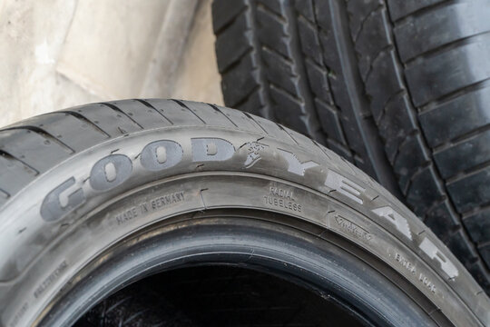  New GOODYEAR car tires on the background of a concrete wall. A set of GOODYEAR Eagle Sport 2 summer, high-quality, reliable car tires. GOODYEAR is a tire manufacturer based in Akron, Ohio, USA.