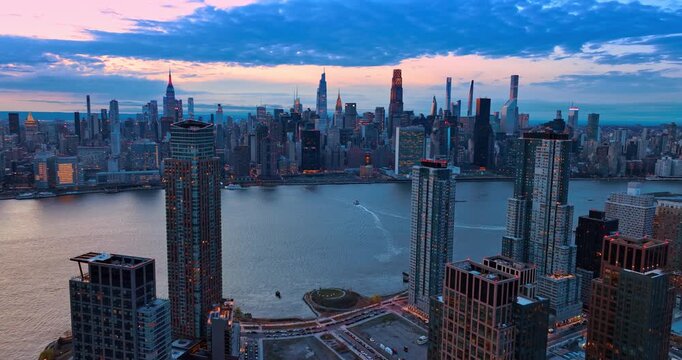 View on East Side Manhattan from Malt Drive in Queens. Drone footage over the waterfront at dusk time. New York, USA.