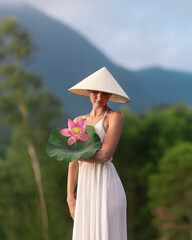 Woman in White Dress Holding Lotus Flower in Vietnam Countryside