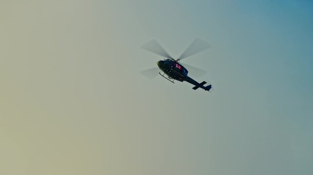 A powerful wide-angle shot of four UH-60 Black Hawk military helicopters flying in a tactical formation against a cloudy blue sky. This cinematic footage represents military cooperation.