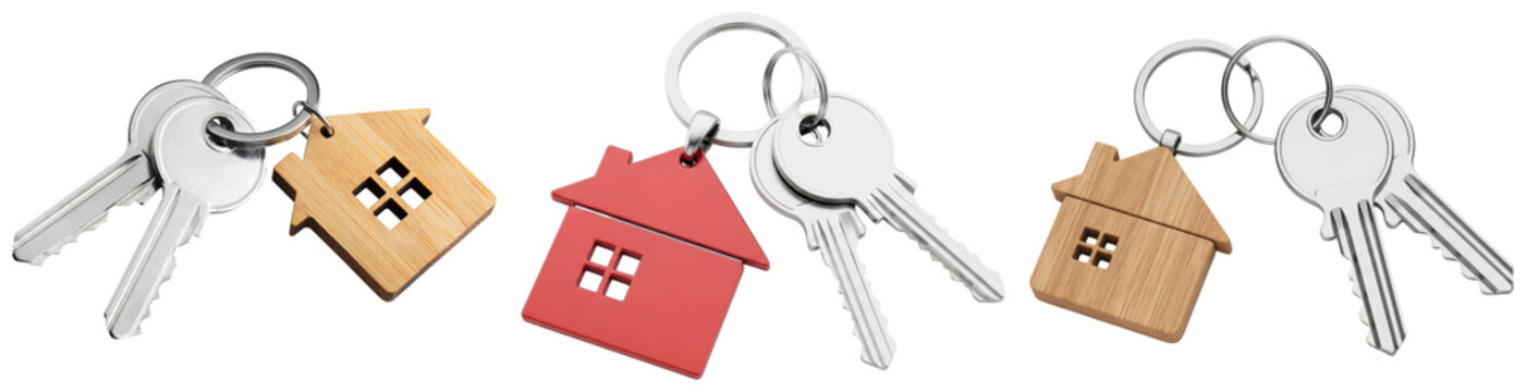 Multiple sets of shiny silver keys with charming house-shaped wooden and red keychains, symbolizing home ownership.