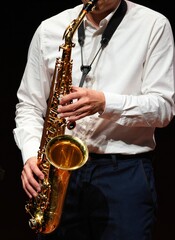 Fototapeta premium Individual Playing Saxophone Main Subject Of Person Middle Aged Older Based On Hands Body Structure Fair Skin Tone With Distinctive Indicate Gender Beyond