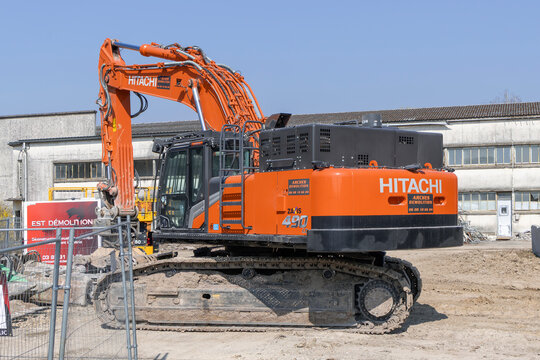 Mirecourt, France - March 21st 2026 : View on an orange crawler excavator Hitachi ZX490LC-7 for the demolition of a building on a construction site.