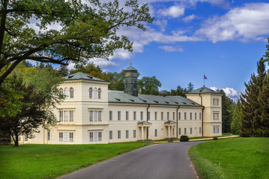 Kynzvart Castle side facade in Cheb District, Czech Republic. Neoclassical architecture with tower under partly cloudy sky