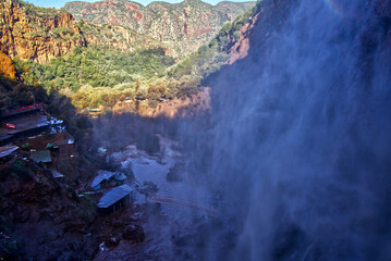 Ouzoud falls immersing valley in mist and spray, powerful cascades shaping an incredible atlas mountains landscape © Frank
