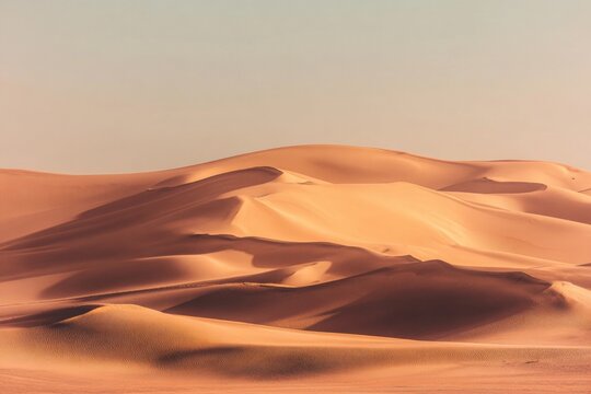 Empty Quarter Desert Dunes. A sea of sand in the Rub' al Khali Desert under atmospheric sunset light. Empty Quarter Desert Dunes near the border of Saudi Arabia and the United Arab Emirates