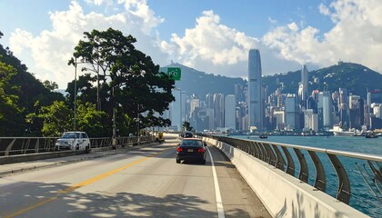 Fototapeta premium A scenic highway by the water with a city skyline