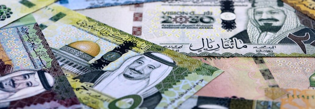 Saudi riyal money bills pile on table. Saudi Arabia banknotes of SAR currency close up.