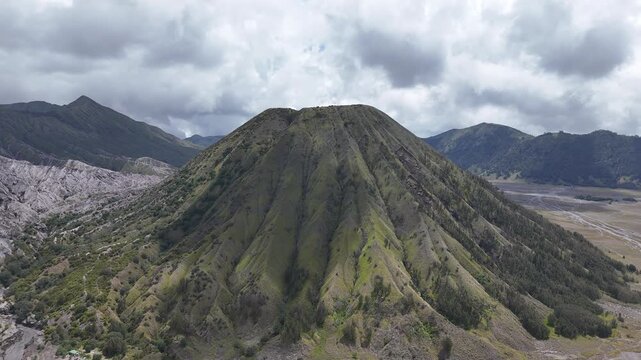 Aerial drone view of Mount Batok volcano in Bromo caldera landscape