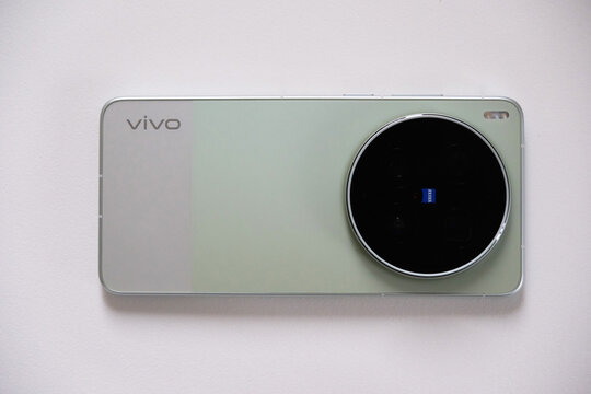 Shanghai,China-April 3rd 2026: Top-down close-up of a green vivo X300 Ultra smartphone with ZEISS camera module