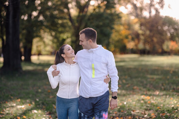 Fototapeta premium Happy couple walking together in park enjoying healthy lifestyle