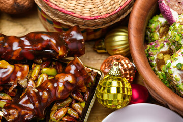 Traditional churchkhela and Turkish delight with golden Christmas balls and pine branches