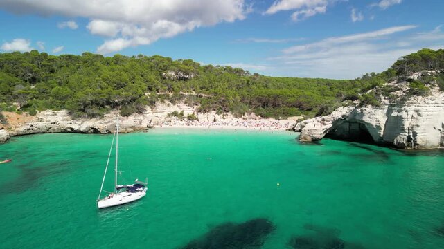 Aerial drone view around Cala Macarella and Macarelleta beach with clean turquoise water, Menorca Island, Balearic islands, Spain. People having sun and swimming in the Sea