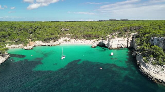 Aerial drone view around Cala Macarella and Macarelleta beach with clean turquoise water, Menorca Island, Balearic islands, Spain. People having sun and swimming in the Sea