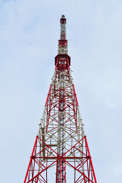 Telecommunications tower, a masthead television antenna against a cloudy sky.
