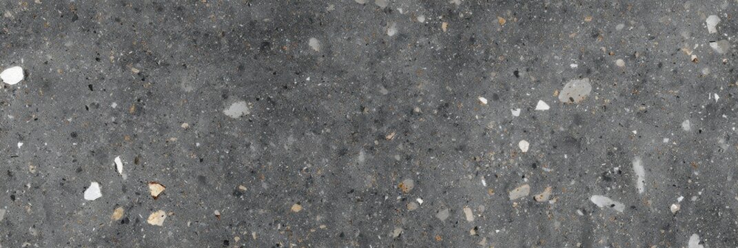 A dark gray terrazzo stone texture featuring a variety of mineral inclusions in white, light gray, and tan shades, creating a flamed and matte surface suitable for background use.