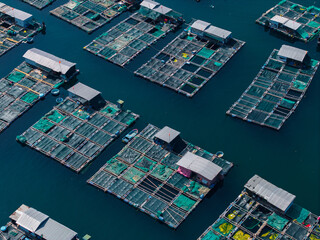 Aerial view Vietnam Floating fish cages and small huts in sheltered coastal waters © Parilov