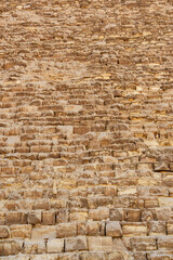 Fototapeta premium Historic stone facade of a pyramid showcasing ancient construction techniques in Egypt during the daytime