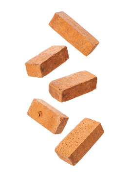Multiple individual red clay bricks with a rustic texture, dynamically arranged and floating in a creative composition.
