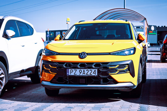 Poznan, Poland - April 2, 2026. Yellow Volkswagen T-Roc II model from 2025 in a parking lot.