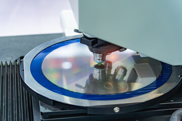 silicon wafer with microchips on machine process examining in microscope and checking quality,integrated circuits to manufacture CPU and GPU