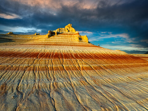 Aerial view of Aktau mountains with layered sandstone formations under a dramatic sky, showcasing nature's artistry, Aktau, Kazakhstan.