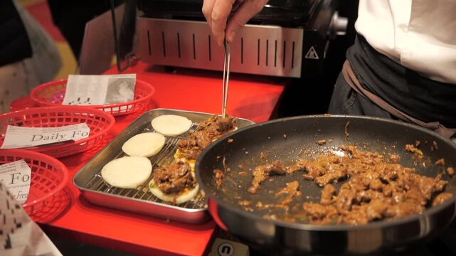 Close-up of a chef&rsquo;s hands preparing meat bao buns