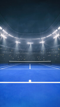 Blue tennis court at a sports arena with glowing spotlights and fans ready for the upcoming night sporting event.