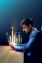 Professional man analyzing financial data on smartphone in a dimly lit office environment