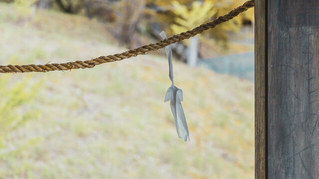 Shimenawa Sacred Rope with Shide Paper Streamer at Japanese Shrine