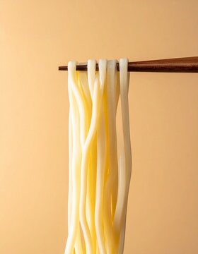 Udon Noodles Lifted with Chopsticks on Light Background