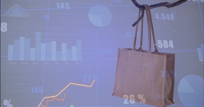 Hanging brown reusable bag showing rope handles on branch at studio set, with charts, copy space