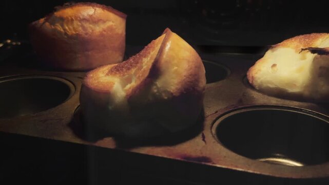A dramatic 4K timelapse capturing Yorkshire pudding batter rapidly rising and browning in a high-heat oven. Perfect for cooking tutorials, food documentaries, or British culinary features.